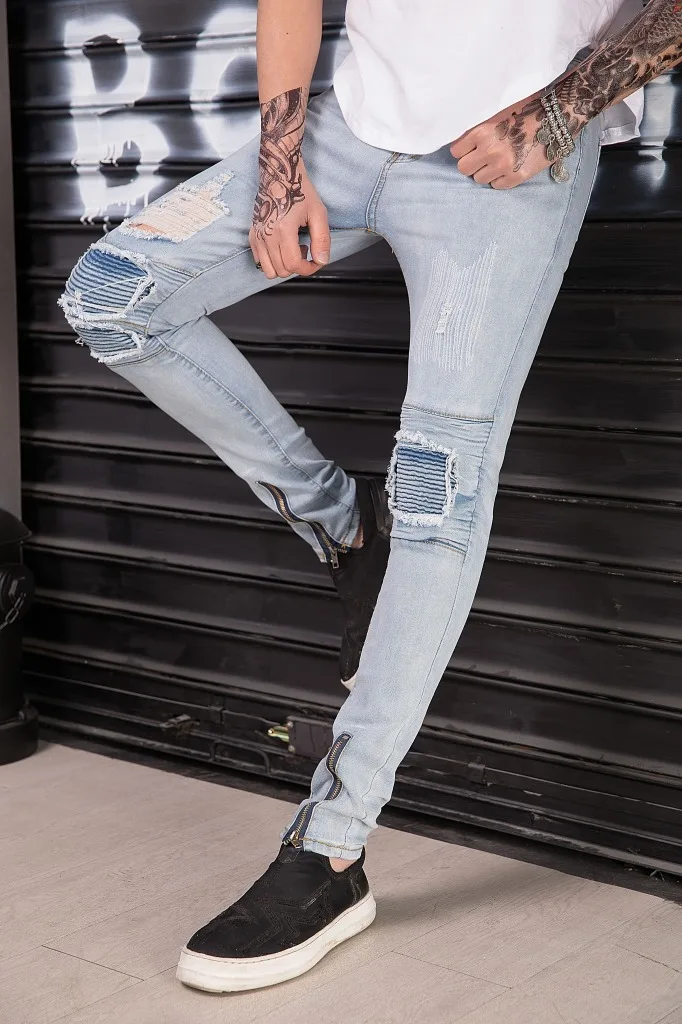 

young man new washing jeans trendy height stretch and feet hole pants
