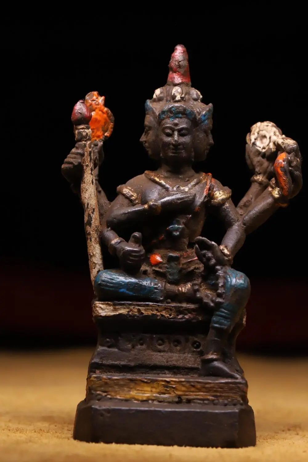 

Tibetan old copper tires are beaten by hand, chiseled, painted on four sides Four-faced Buddha head with six arms statue