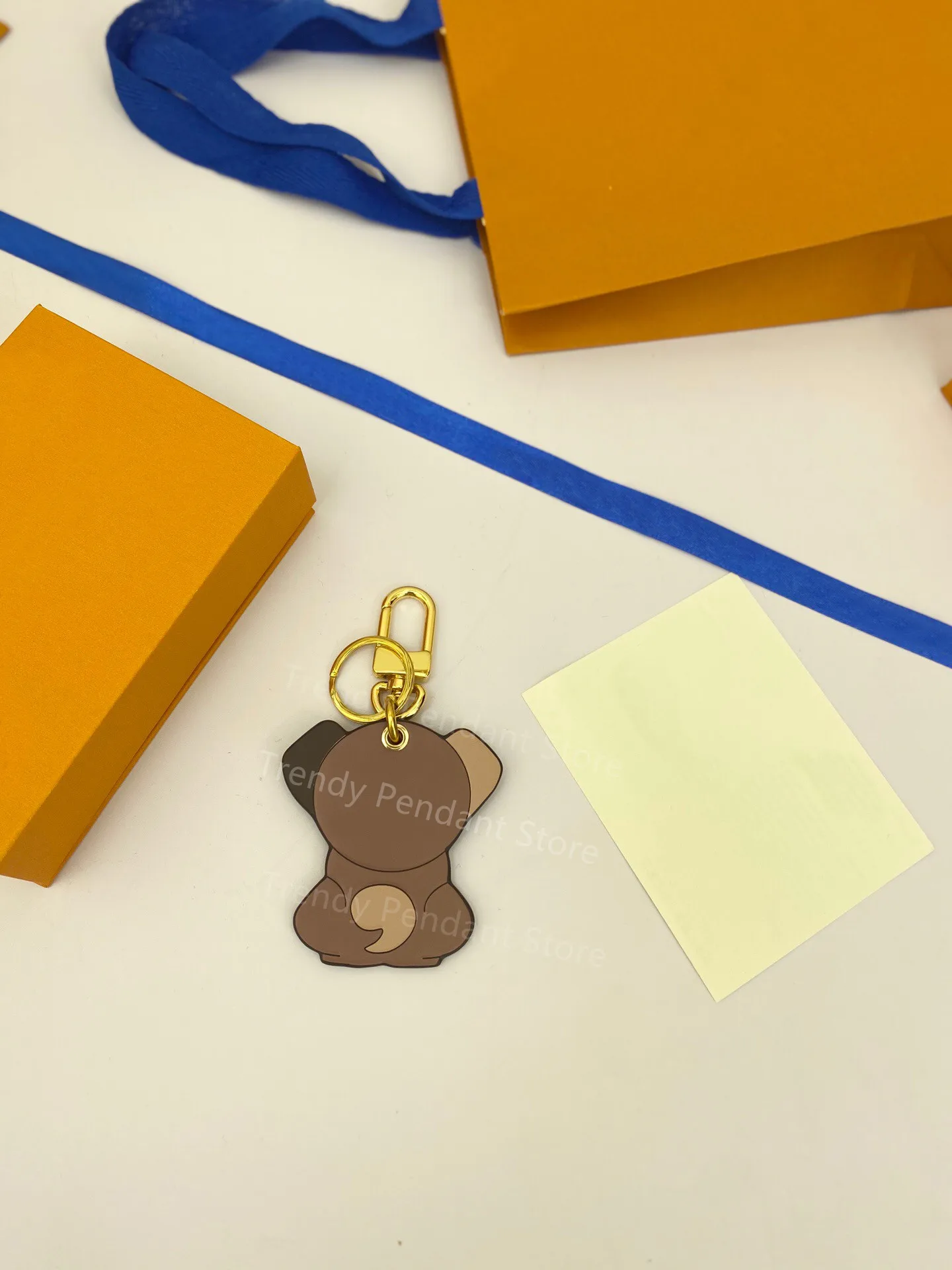 

New Luxury Brand Brown Leather Old Flower Four-Leaf Clover Puppy Keychain Fashion High-Quality Bag Decoration Pendant Keychains