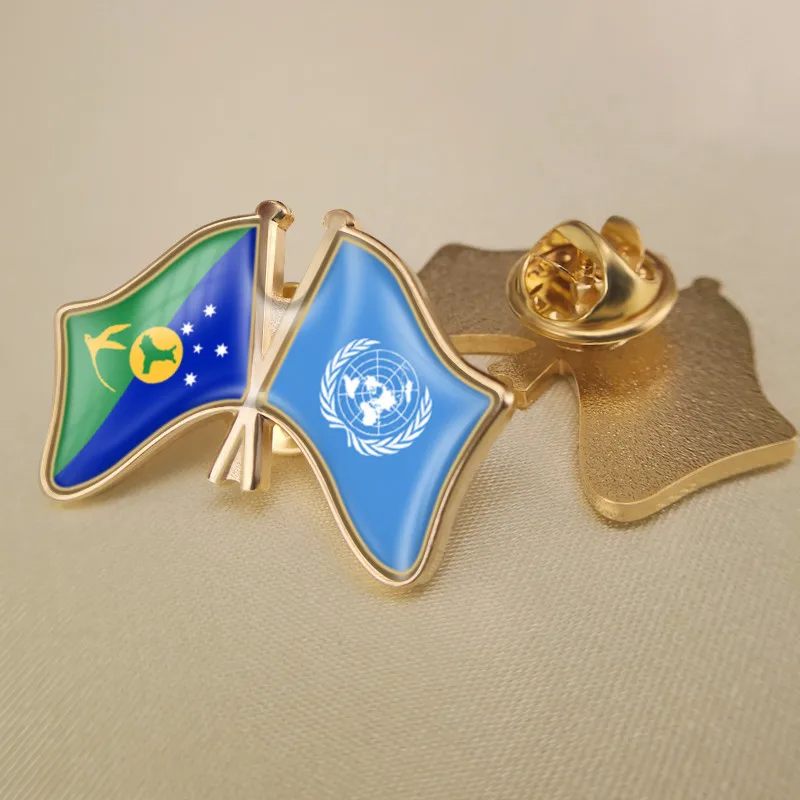 Брошь в виде двух соединенных элементов с изображением ООН и рождественского