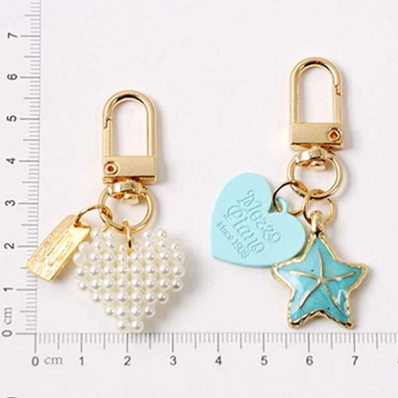 

Hot Sales Ins Five-pointed Star Shell Keychains Pendant Bluetooth Headset Case Key Chain Bag Pendant Key Chain 2021 New