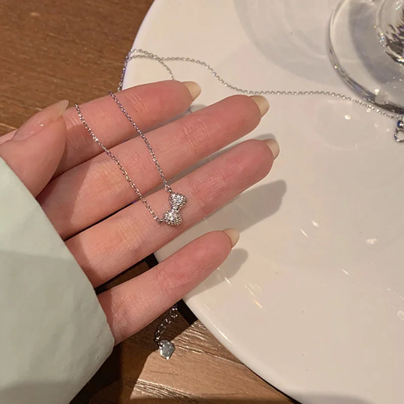 

Лидер продаж, кулон в виде банта серебряного цвета с блестящим цирконием, длинная цепочка, ожерелье, женская бижутерия, бант, цепочка до ключ...