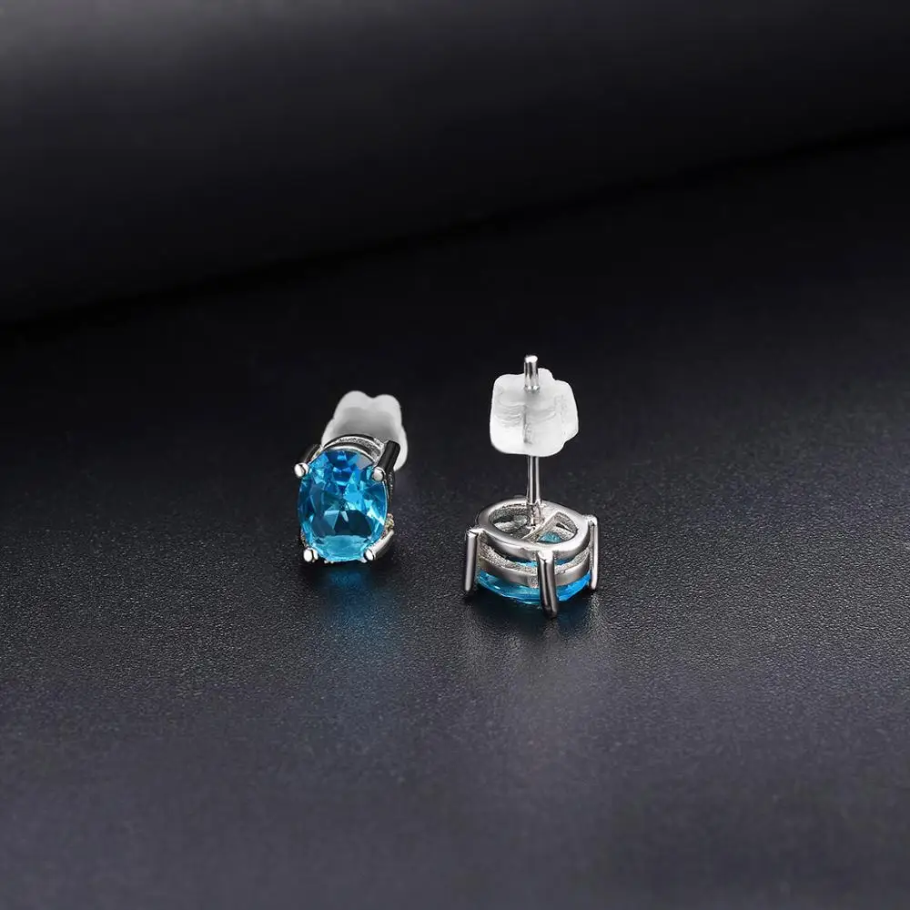 Серьги-гвоздики из серебра 925 пробы с голубым топазом 7*5 мм овальный камень