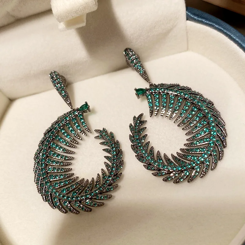 

Diamond personality green leaf earrings sexy green leaf arc tide online celebrity exaggerated earrings female tropical leaves