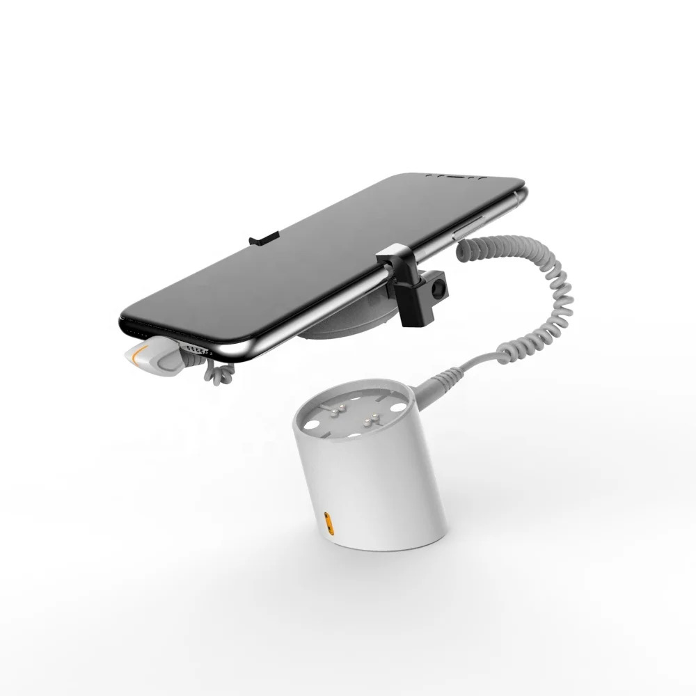 

Magnetic smartphone secure display holder with charger function