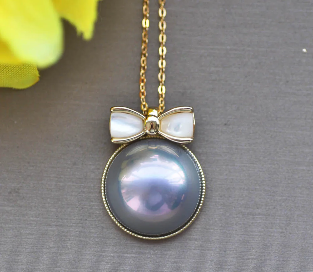 

Z11110 Lustre 16mm Blue Shell Mabe Pearl Bowknot Chain Pendant CZ