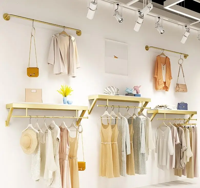 Clothing store upper wall display rack Simple wall-mounted clothes hanger display rack for women's clothing store.