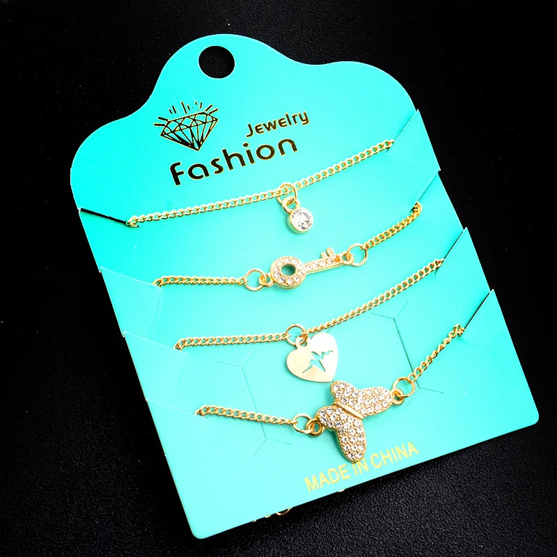 Женский браслет с кристаллами в виде бабочки и сердца 4 штуки золотого цвета