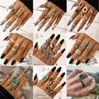 Женское кольцо в виде змеи с зеленым кристаллом