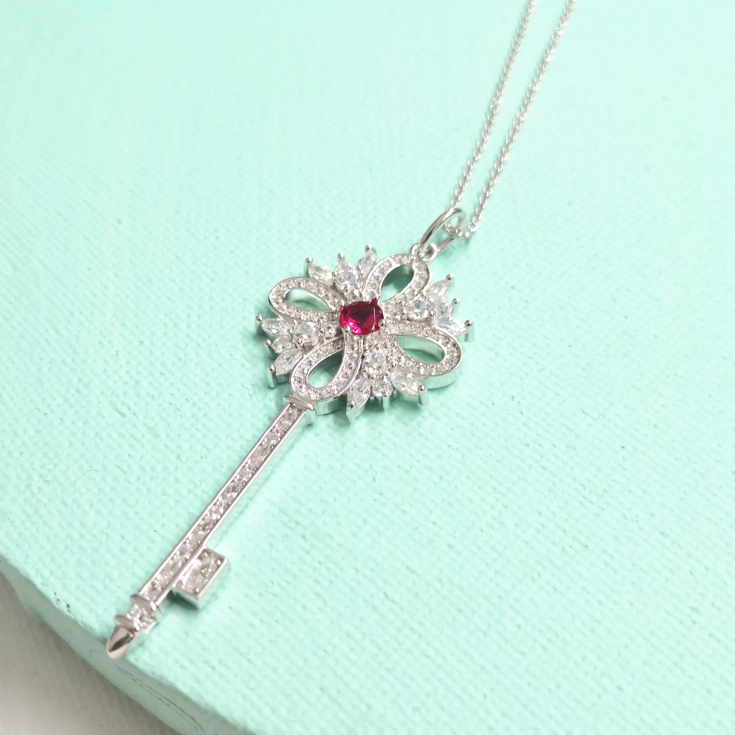 

Classic Female S925 Sterling Silver Hollow Key Inlaid Red Dark Blue Zircon Pendant Necklace Sterling Silver Key Sweater Chain