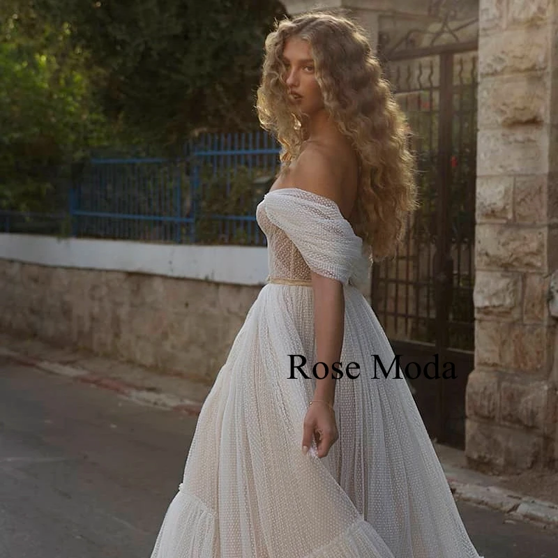 

Rose Moda Off the Shoulder Sleeves Glittering Lace Boho Wedding Dress with Sash Custom Make