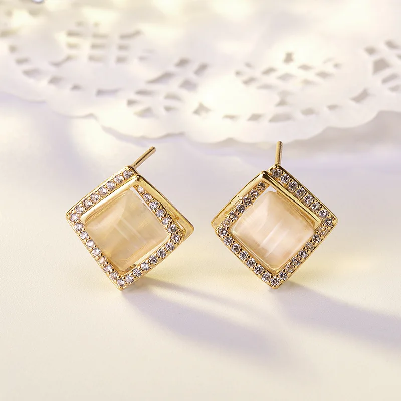 

Korean version advanced sense micro-inlaid diamonds earrings. Female transparent cat's eye stone gentle girl square ear jewelry.