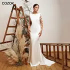 Платье свадебное атласное с юбкой-годе, овальным вырезом и длинными рукавами