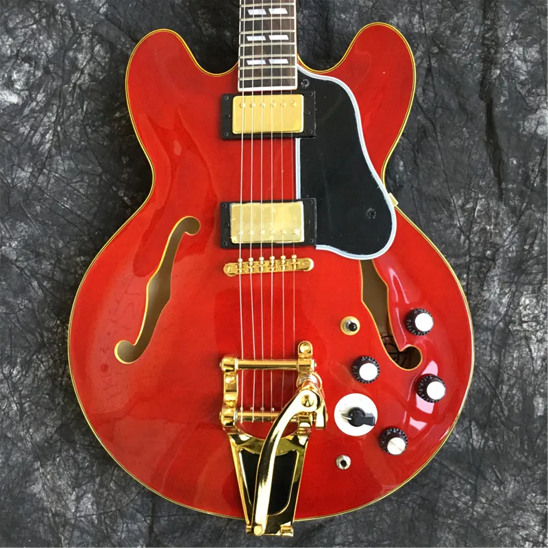 

Custom high-quality jazz electric guitar, red, maple flame top. Gold, 6-speed, double F holes.