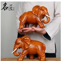 a pair elephants were carved out yellow flowers pear wood home decoration statue factory direct selling