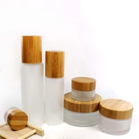 wholesale 100ml frosted glass spray bottle with wood grain bamboo cap cosmetic emulsion pump container packaging