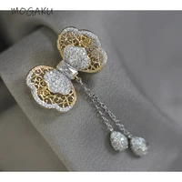 mogaku retro gold color bowknot brooches women fashion tassel pins delicate personality designer hollow out metal brooch ladies