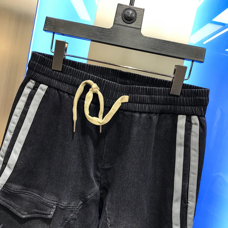 

Men's casual pants 2020 autumn new fashion personality lace up simple side stripe jeans long pants handsome and versatile