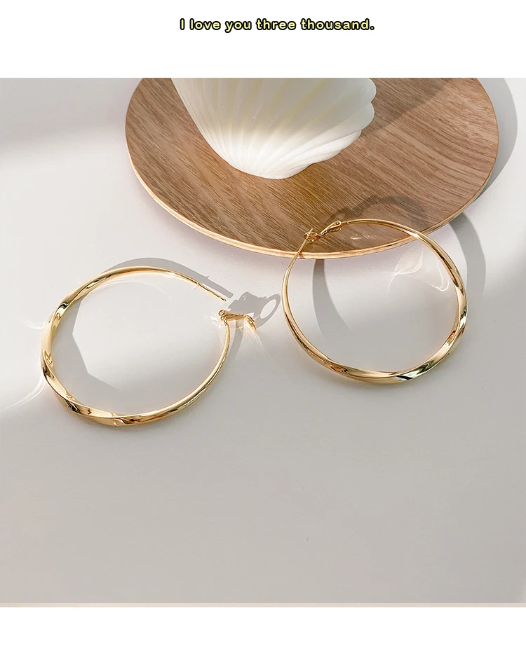 

Woman Gold-plated spiral circle exaggerated earrings personality wild European and American high sense pure silver earrings