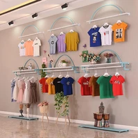 mens and womens clothing store shelf blue on the wall childrens shop display shelf shopping mall hanging clothes rack