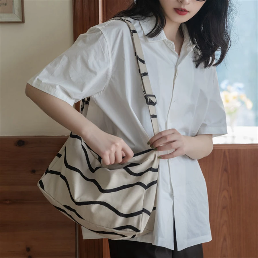 

Women Canvas Shoulder Bag Girls Stripe Artistic Students School Package Ins Fashion Cross-body Portable Traveling Black White