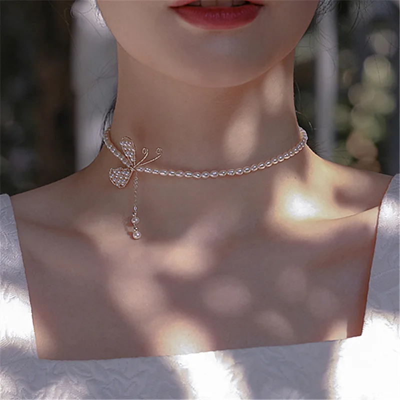 

LOVOACC Handmade White Pearls Butterfly Wings Choker Necklace for Women Imitation Pearl Beaded Tassel Brass Pendant Necklaces