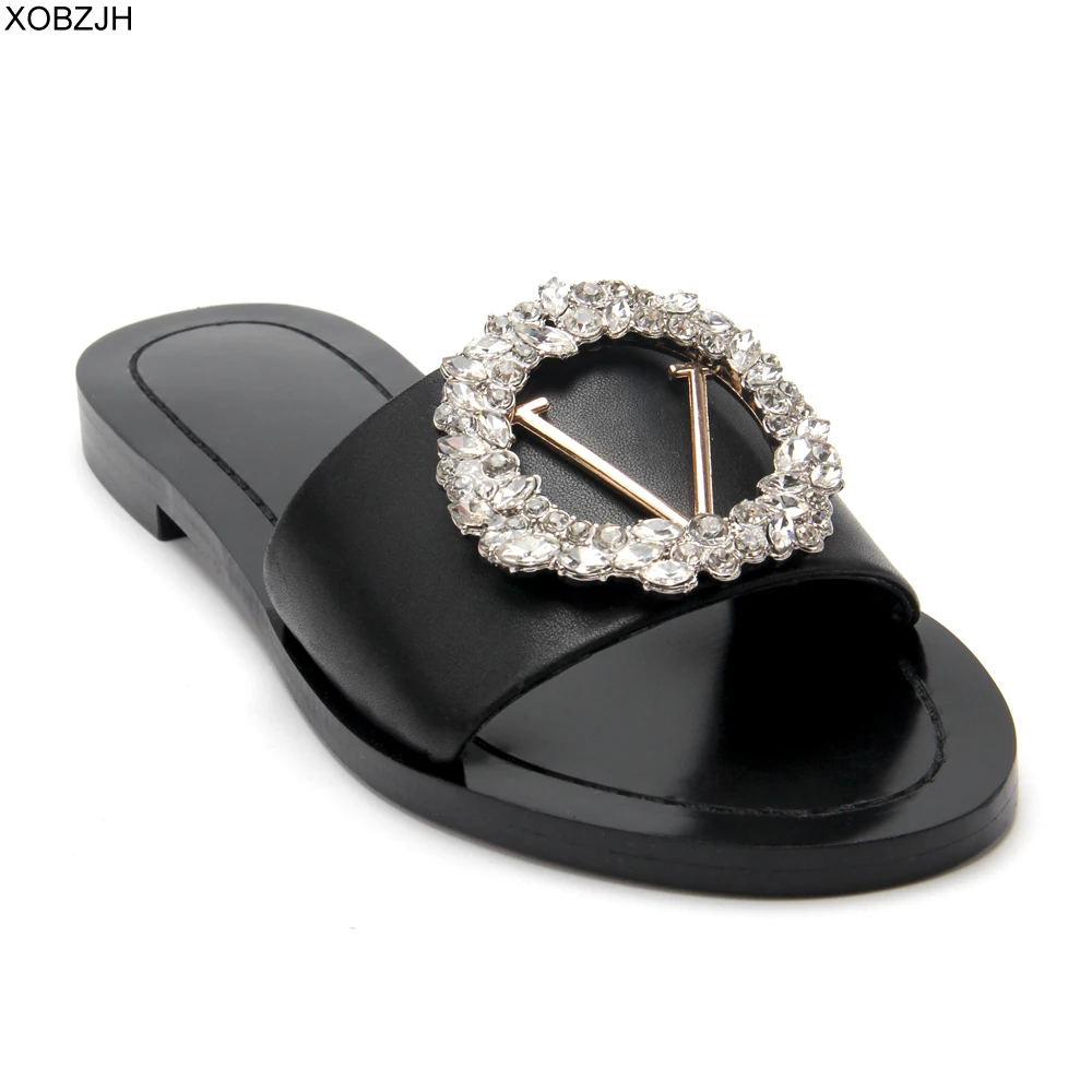 Женские дизайнерские шлепанцы черные из натуральной кожи на плоской подошве