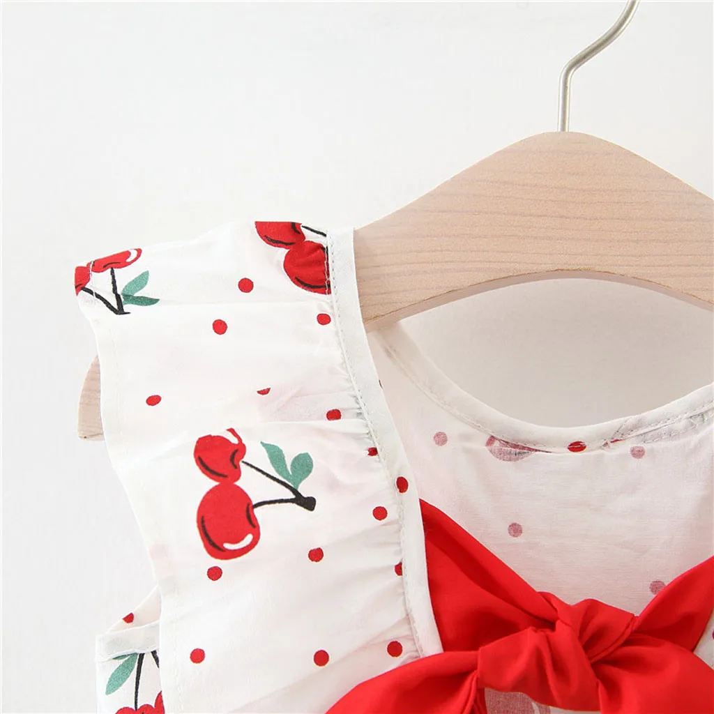 Летнее платье в горошек без рукавов с бантом