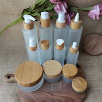 empty high quanlity bamboo matte glass lotion bottles and face cream jars cosmetic container packaging refillable bottles bulk
