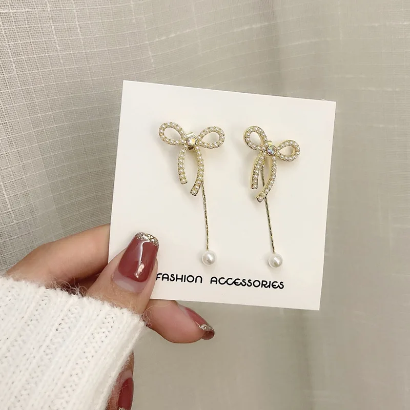 

Sweet Temperament Pearls Designer Earrings Hollow Bowknot Copper Earrings Dangle