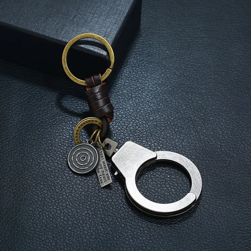 

Woven cowhide keychain Small gift alloyed movable handcuffs leather key chain