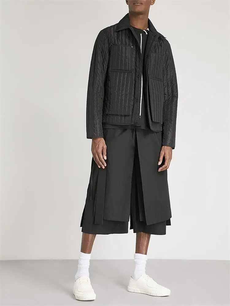 The new men's cropped trousers are dark and large size loose trousers with irregular asymmetrical wide legs