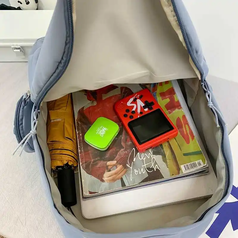 

Japanese solid color female fashion backpack cute student backpack with nylon pendant on high-capacity travel packs