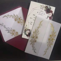 burgundy invitation card with gold foil flower envelope and translucent vellum jacket for wedding bridal shower rehearsal