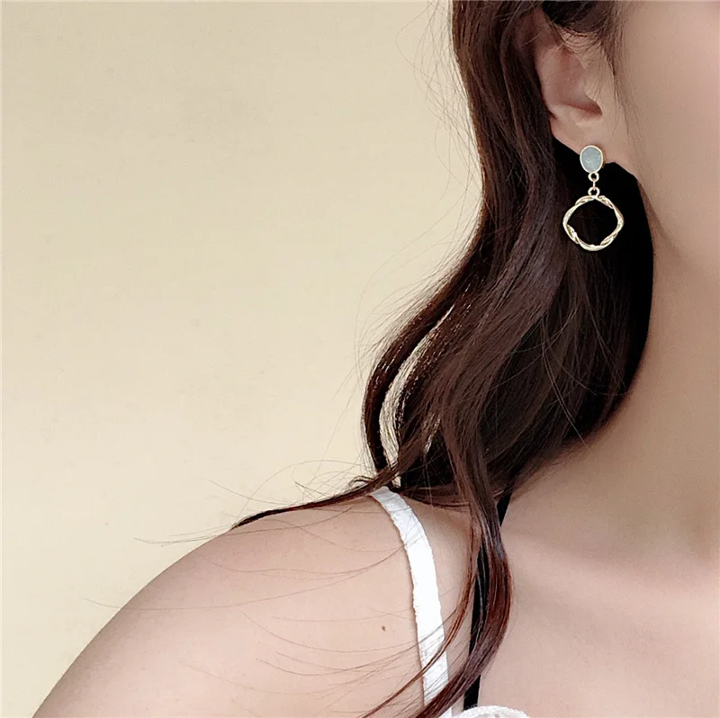 

Temperament contracted twist flower earrings irregular cold wind hollow metal circle stud earrings