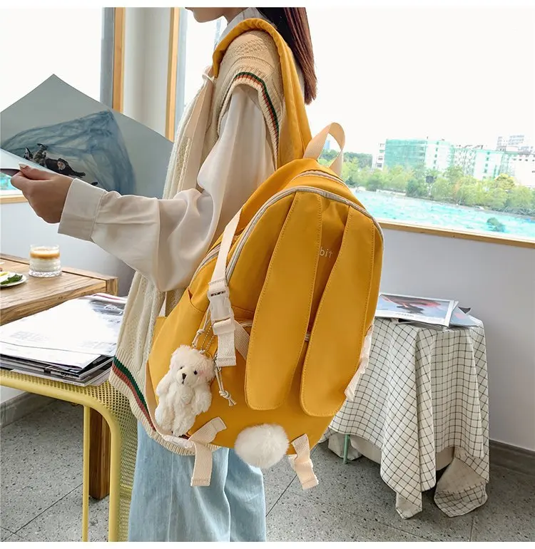 

College wind cute cartoon personality rabbit ears hair ball student schoolbag versatile solid color lovely girl backpack