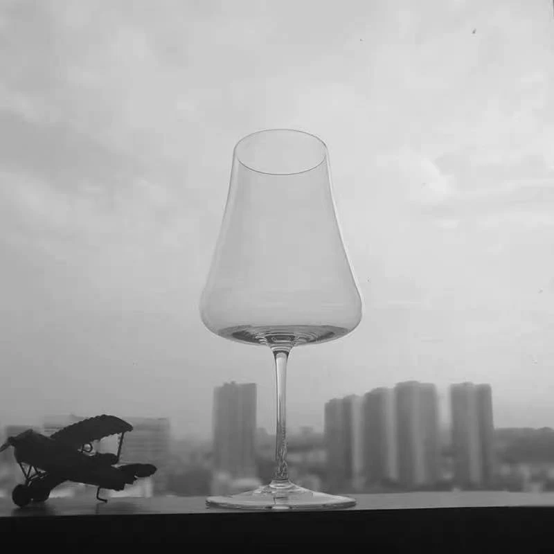 

The Slender Red Glass Is Handmade and Shaked In A Tall Wine Tasting Goblet