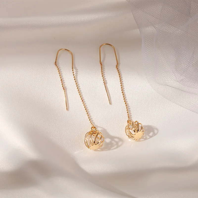 

Korean version of thin ear line female hollow ball temperament earrings long tassel Dongdaemun trend new ear jewelry