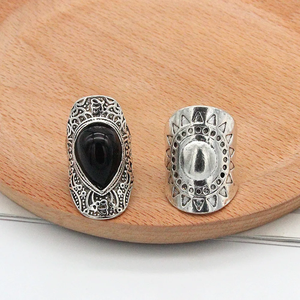 

New 2021 European and American retro ethnic black gemstone water drop sun pattern palace hollow carved 4-piece alloy ring