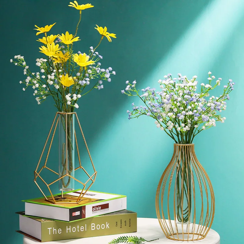 

Small transparent wrought iron vase on the dining table, small golden metal glass vase, flower arrangement in the living room