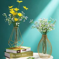 small transparent wrought iron vase on the dining table small golden metal glass vase flower arrangement in the living room