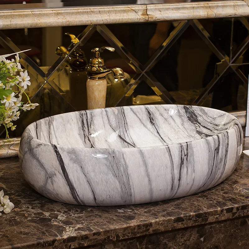 Керамическая раковина над прилавком овальная с Европейским мраморным узором