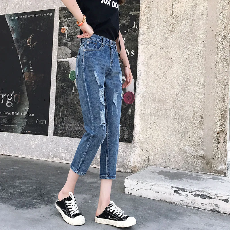 Новые стильные женские джинсы с потертостями на бедрах поврежденным карманом