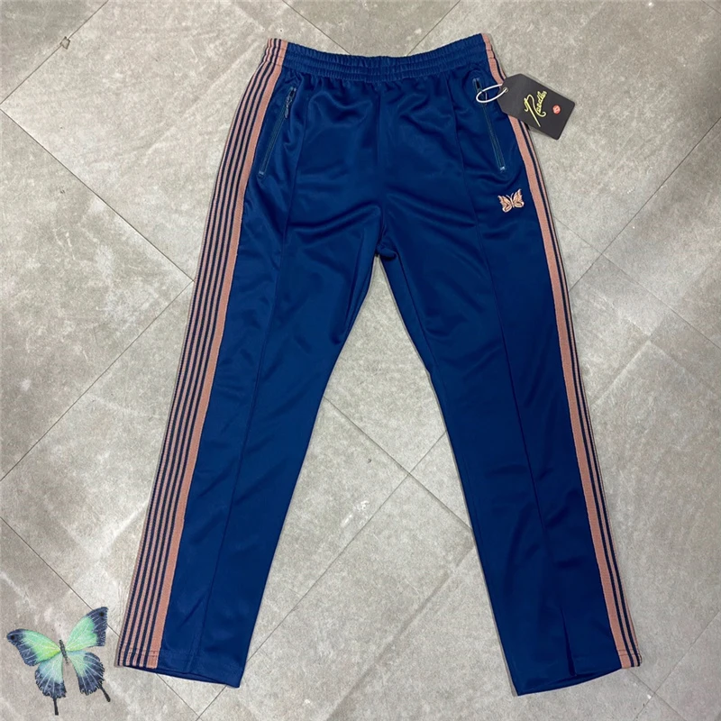 

Sea Blue Needles Pants Men Women Stripe Butterfly Embroidery Logo Ribbon AWGE Track Pants