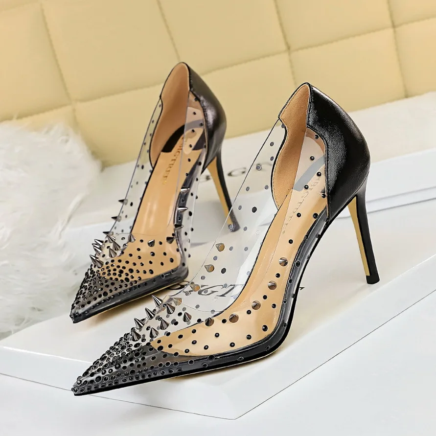 

European and American Sexy Metal Rivet Thin Heel High Heel Shallow Pointed Transparent Rhinestone Splicing Hollow Shoes
