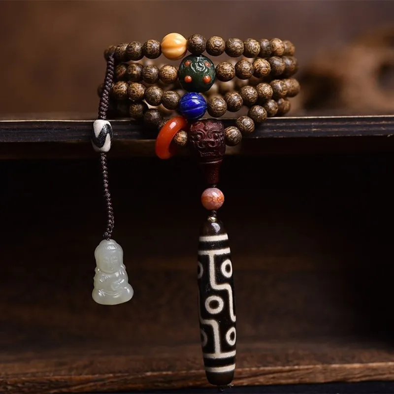 

Original design new to pure Tibetan nine-eyed dzi pendant with authentic Western-style sloppy agarwood