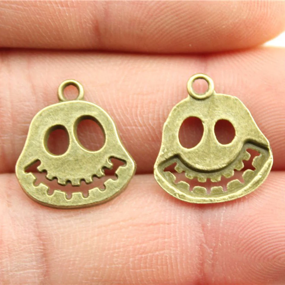 

WYSIWYG 20pcs/lot Smile Skull Charms For Jewelry Making 15x17mm Antique Bronze Plated Accessories