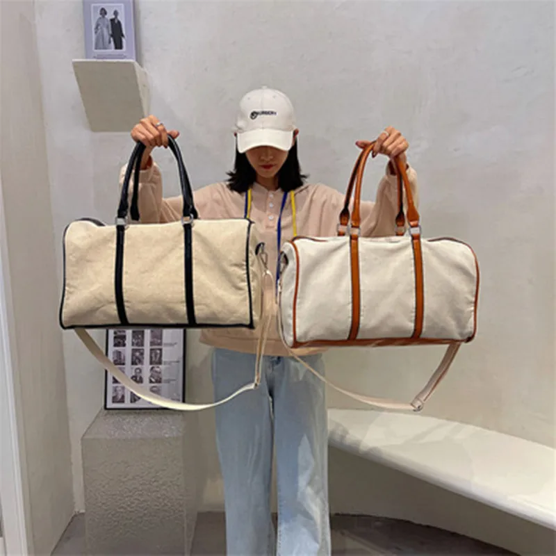 2021 new female hand proposes a large capacity autumn short-distance travel luggage bag Korean canvas messenger large bag