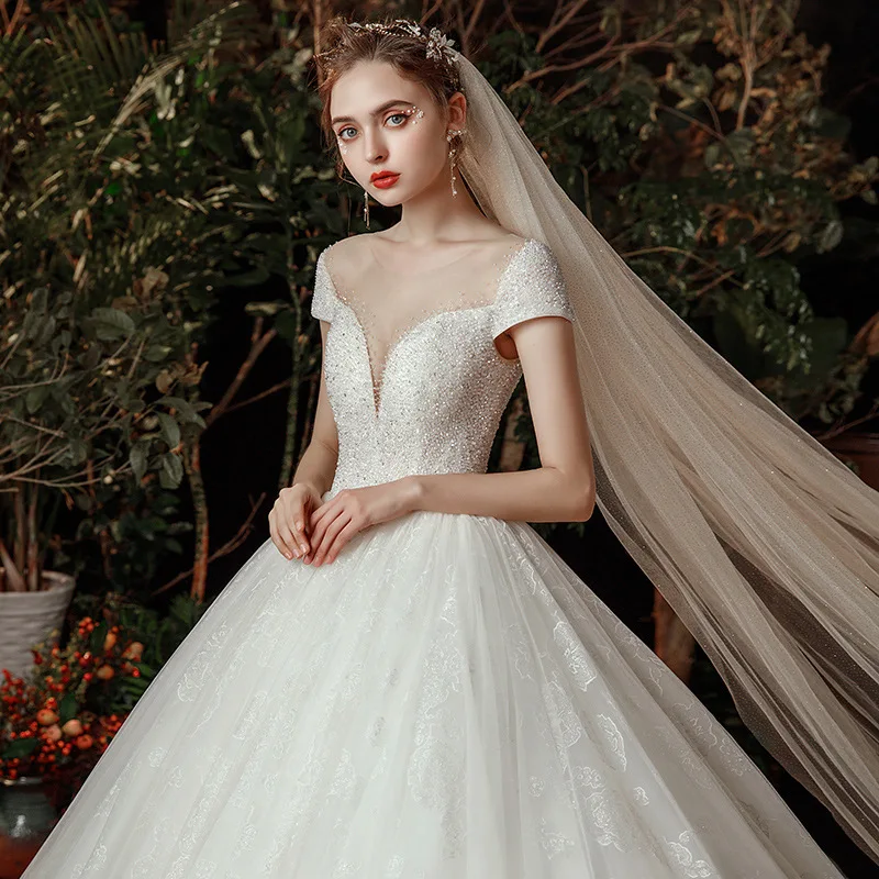 

Luxury Princess Wedding Dresses Sexy Illusion O Neck Backless Lace Short Sleeves Castle Beaded Bridal Gowns Chapel Train Vintage