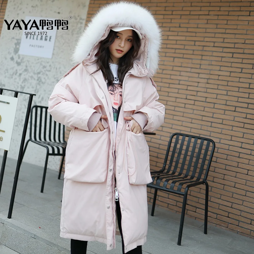 

Женский пуховик YAYA на белом утином пуху, с воротником из меха енота и капюшоном, длиной выше колена, теплая верхняя одежда с большими кармана...
